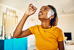 Woman testing for virus, disease and illness during covid pandemic at home. One sick, ill and black female using a self medical test kit to check for sickness on a table or counter alone at home