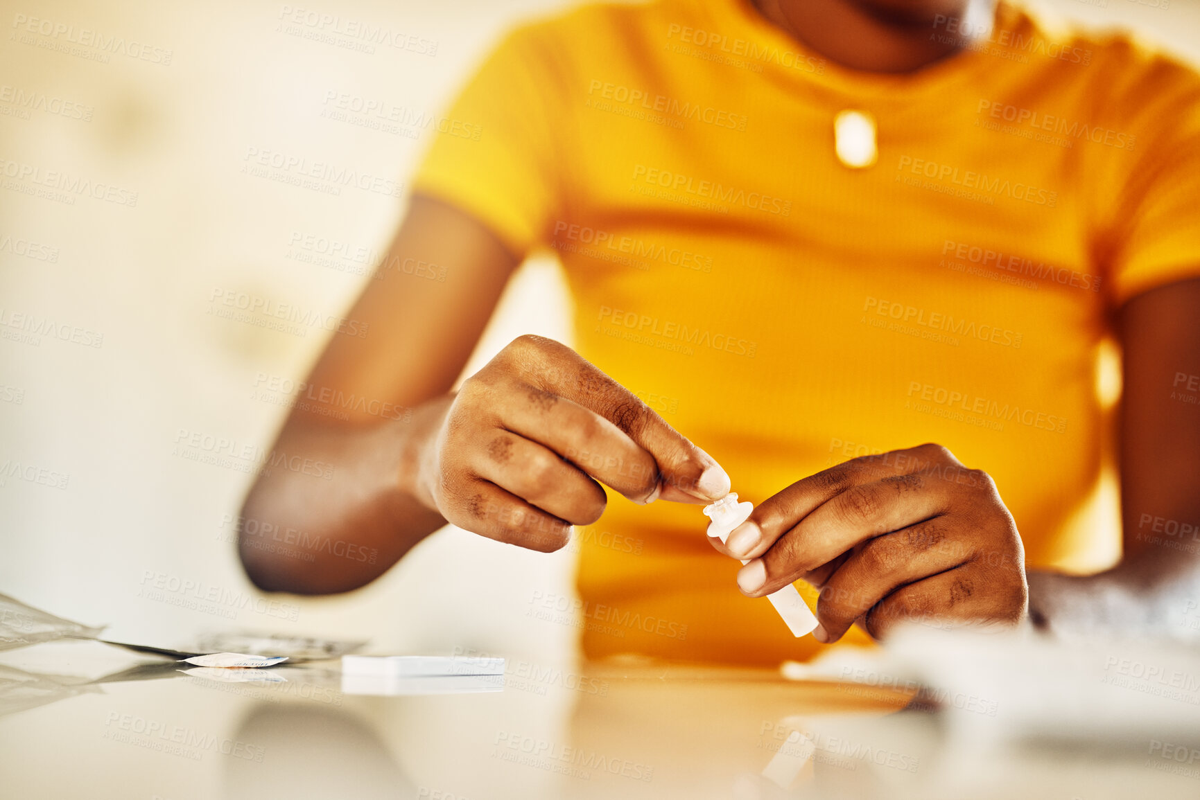 Buy stock photo Hands of African female with HIV and Aids at home blood self test kit sitting at a desk waiting to check for results. Closeup of young afro woman with medicine or pills for a medical condition.   