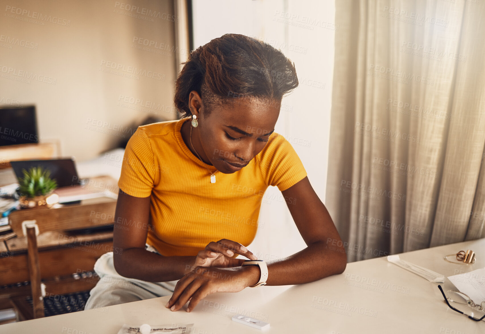 Buy stock photo Young, worried and stressed black woman waiting for the results of covid test. African American woman looking at the time on a smart watch and anxious or fearful about her medical and health status