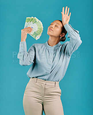 Buy stock photo Woman showing off money, looking rich with cash prize and winning the lottery while standing against a blue studio background. Female billionaire holding bank notes and looking confident with salary
