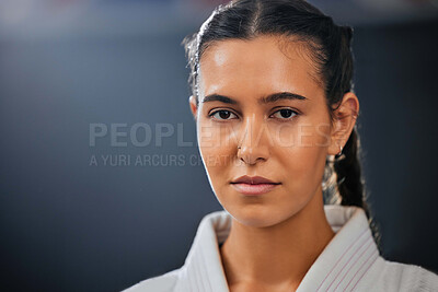 Buy stock photo Portrait of female athlete, serious, and in karate gear staring ahead. A young girl, healthy, with a determined and motivated face at martial arts training. Discipline, fight and fitness in the dojo.