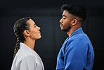 Mma, martial arts and self defense training or practice with a man and woman having a face off in studio against a black background. Man and woman in gi or uniform ready to fight in combat sport