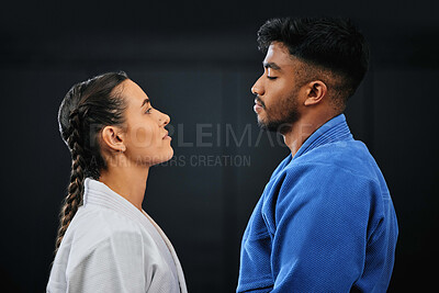 Buy stock photo Mma, martial arts and self defense training or practice with a man and woman having a face off in studio against a black background. Man and woman in gi or uniform ready to fight in combat sport
