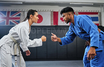 Buy stock photo Karate, mma and fitness with a teacher and student learning, training and doing a workout for exercise, sport and health. Man and woman in fight, combat or self defense class in a gym studio