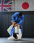 Martial arts, karate or judo fighters and athletes fighting in a competition, match or tournament. Japan vs UK, self defense and protection professionals with skill fight in a dojo to win and compete