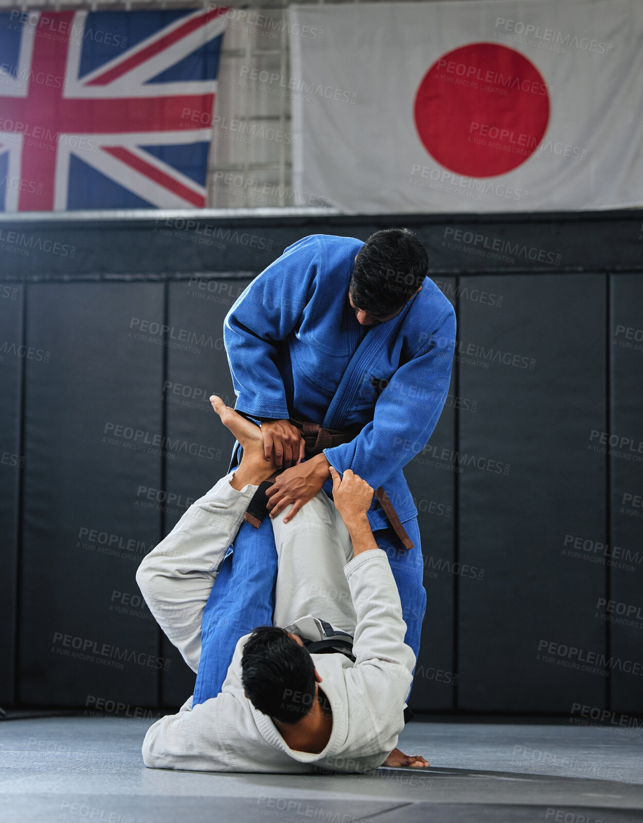 Buy stock photo Martial arts, karate or judo fighters and athletes fighting in a competition, match or tournament. Japan vs UK, self defense and protection professionals with skill fight in a dojo to win and compete