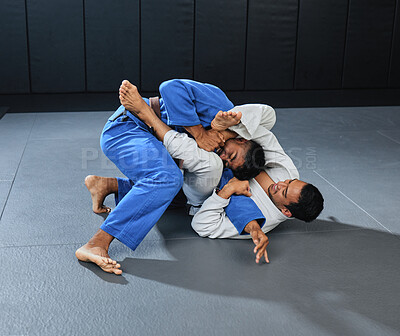 Buy stock photo Mma, martial arts and fighting with a student and teacher grappling on the ground during a lesson or workout in a sports studio. Training, practicing and sparring for self defense and combat sport