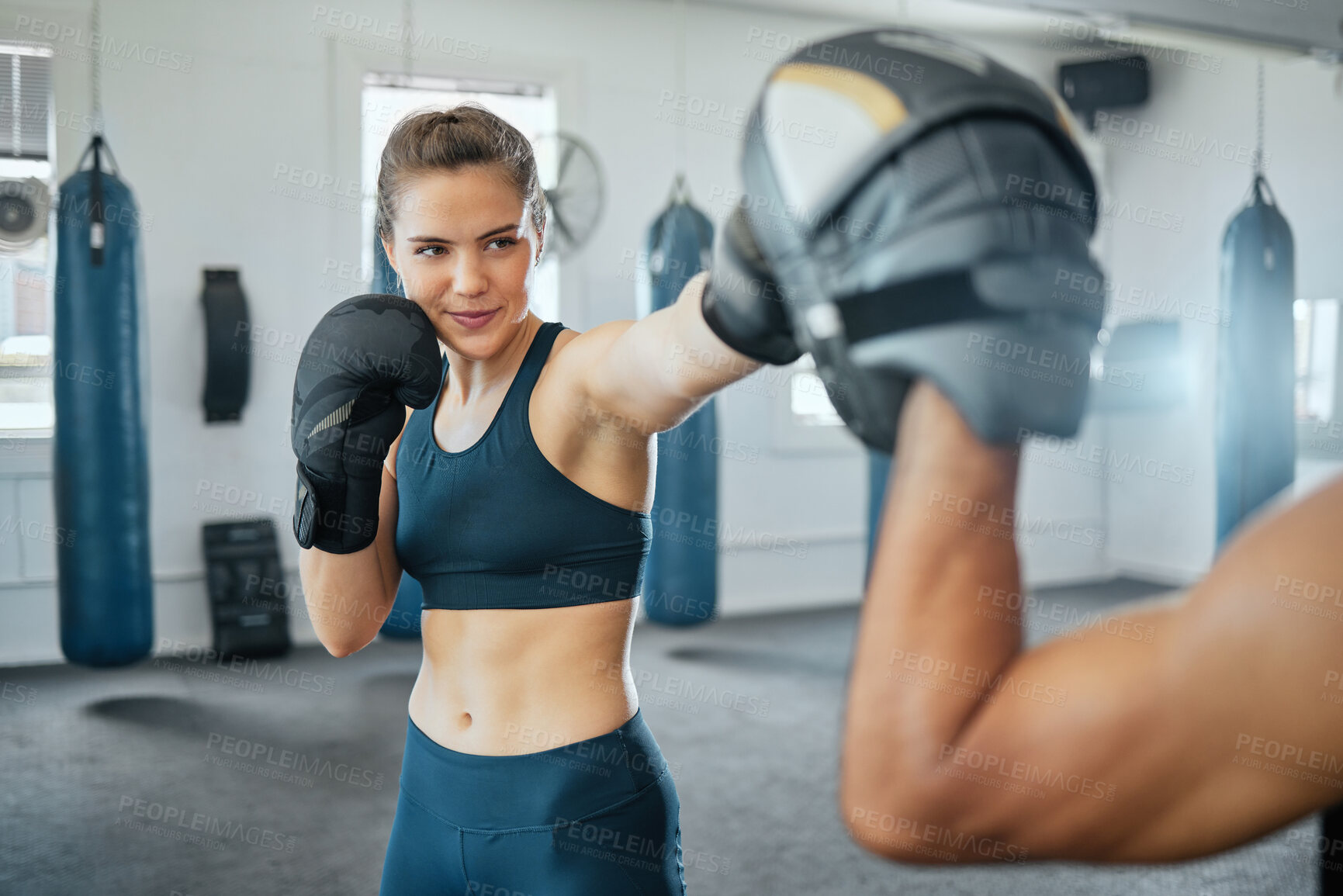 Buy stock photo Boxing woman, team training and fitness cardio workout at gym, doing strength exercise with coach and learning female self defence with a trainer. Active instructor helping girl with health goal