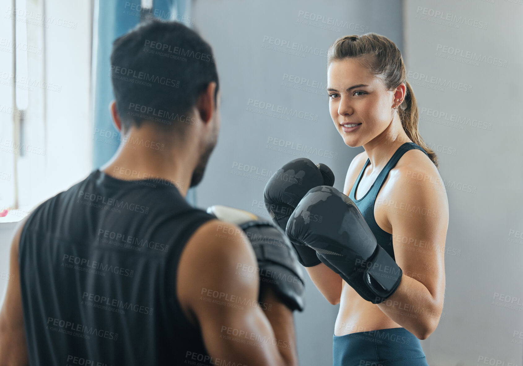 Buy stock photo Boxing woman training with a fitness coach at gym, learning cardio workout at sport club and doing self defense exercise with trainer at health club. Man teaching a girl physical activity at center