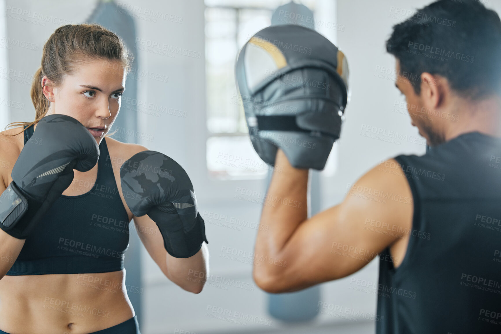 Buy stock photo Boxing female boxer at gym with sports personal trainer practicing or training together for fight or match. Fitness and wellness coach teaching fit active athlete or client fighting exercise workout