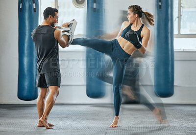 Buy stock photo Fighting female training with coach, learning kickboxing exercise at gym and doing cardio fitness workout for wellness with trainer at health club. Woman and man staying, active, healthy and sporty