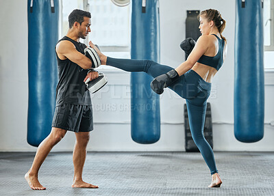 Buy stock photo Training kickboxing and learning to fight, a male trainer and woman getting fit in gym. Fitness, motivation and female empowerment. Strong kick and healthy exercise, a young lady and her sports coach