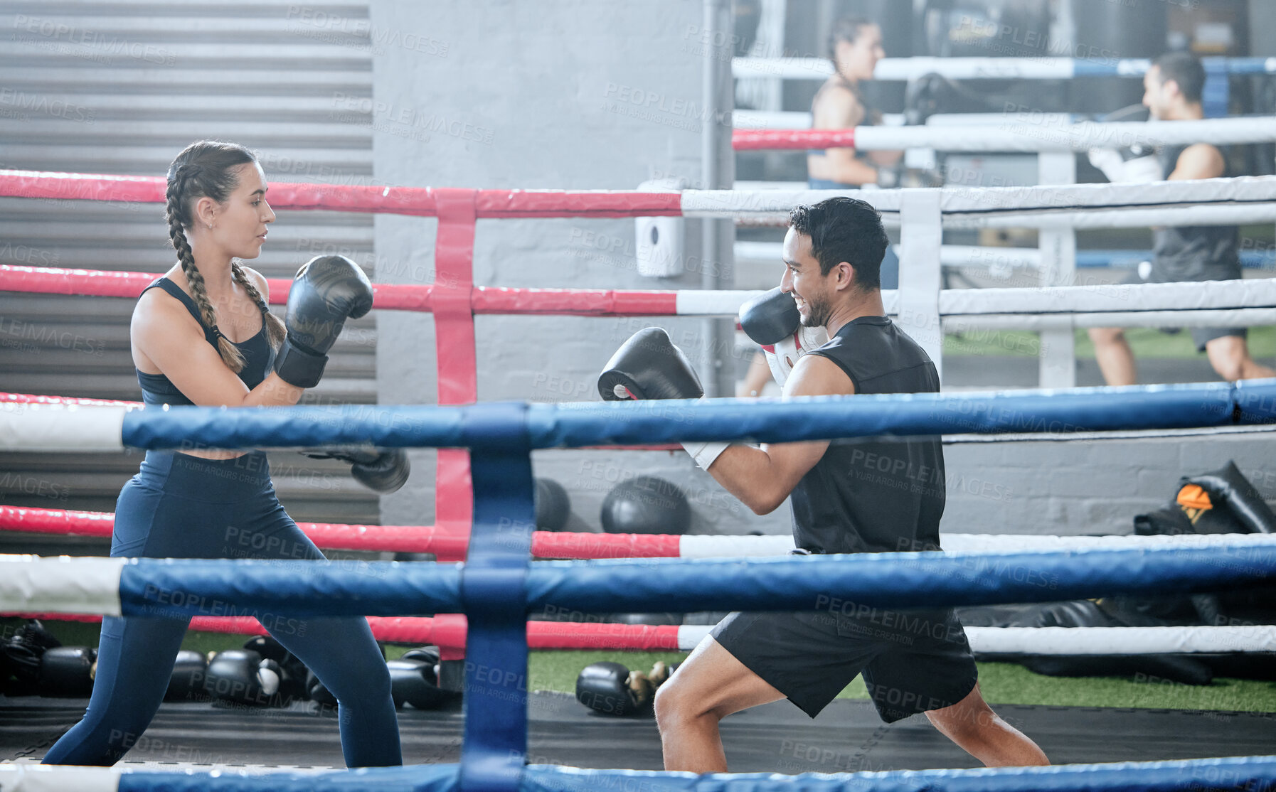 Buy stock photo Boxing, training and exercising with a healthy, fit and active female boxer and her male coach or personal trainer in the gym. Workout, fitness and exercise with an athlete and her sports instructor