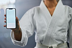 Sports marketing, advert and copy space on blank phone screen to signup for martial arts club training and exercise in gym. Closeup of karate trainer, sensei and coach endorse, recommend and promote