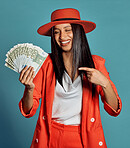 Stylish, elegant and trendy rich young woman holding cash, competition or lottery winnings pointing. Happy, excited and celebrating female cheering with income, savings or return on investment