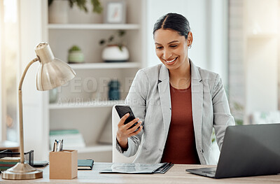 Buy stock photo Freelance and remote working business woman checking her phone, reading a message or sending a text in her home office. Motivated, happy and positive female professional sitting at her desk at work