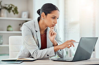 Buy stock photo Serious, laptop and professional businesswoman sitting and reading a work email with a pen working from home. Business, computer and focused female lawyer in modern office preparing for a case.