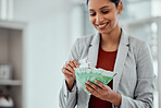 Financial growth, retirement saving and holding money notes by a young female with cash indoors. Bank notes showing growing investment, banking capital and finance budget of a smiling and happy woman