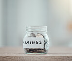 Savings, money and finance with many silver coins in a jar for retirement, banking and investment growth. Start to save for college, pension or wealth with financial freedom from saved income 