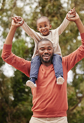 Buy stock photo A young black father playing with his daughter happy, smiling and bonding while enjoying quality time together. A little girl, child or kid having fun and sitting on her dad or parent's shoulders