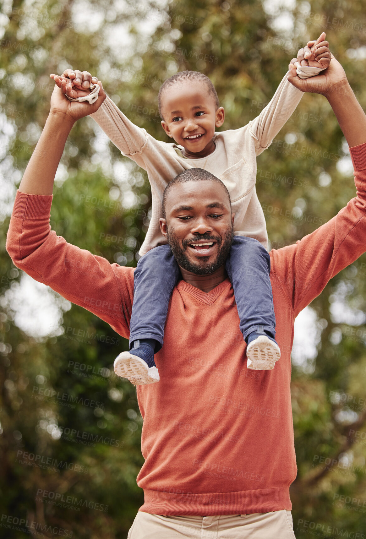 Buy stock photo A young black father playing with his daughter happy, smiling and bonding while enjoying quality time together. A little girl, child or kid having fun and sitting on her dad or parent's shoulders