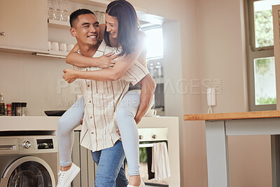 Buy stock photo Happy, playful and excited couple playing in the kitchen at home and the boyfriend giving a piggyback ride to his girlfriend. Carefree and joyful lovers having fun together and enjoying the weekend