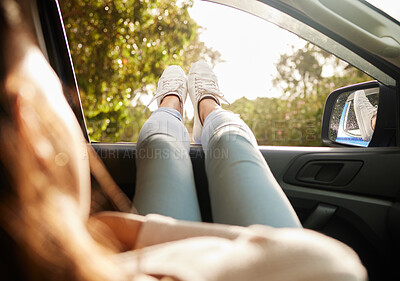Buy stock photo Relaxed, content and happy woman relax while enjoying the sunny morning in a car. Back view of female with feet out her window taking a break from driving sitting and enjoying the summer sunshine day