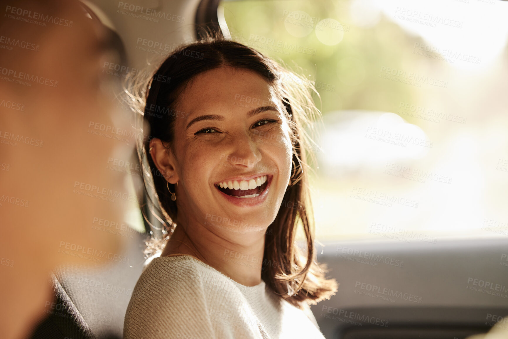 Buy stock photo Happy, cheerful and laughing woman enjoying a road trip, holiday or vacation with her boyfriend in the car. Latino woman having fun in a vehicle while on a journey to a romantic destination