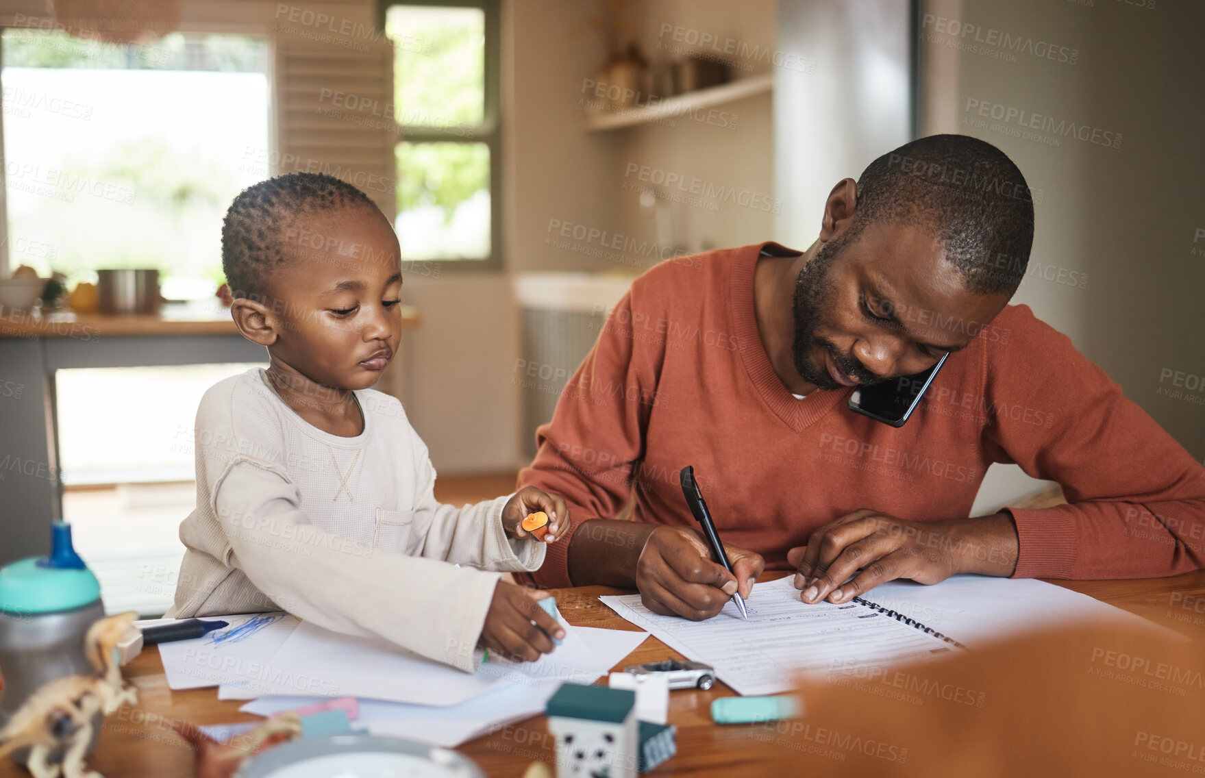 Buy stock photo Busy, working and multitasking father talking on phone, writing on paperwork and networking single dad sits with son. Adorable, little and cute boy playing while freelancer parent works from home