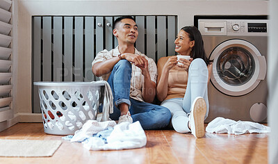 Buy stock photo Couple, chores and laundry while doing home cleaning and feeling happy while talking and relaxing together. Boyfriend and girlfriend with healthy communication while sitting together on wash day 
