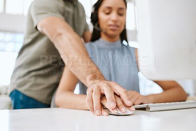 Buy stock photo Sexual harassment or abuse by a business man of a female employee by putting his hand on hers. Unhappy and scared female coworker feeling uncomfortable due to inappropriate touching in the office