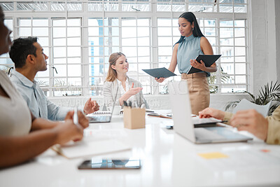 Buy stock photo Female intern, assistant or employee handing out an information document to a team during a boardroom meeting. Group of business people discussing the mission, vision and strategy for company growth