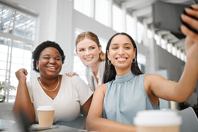 Buy stock photo Happy, motivation and smiling for selfie on phone while having fun and sitting together as a team during break. Diverse and carefree group of female office colleagues posing for social media post