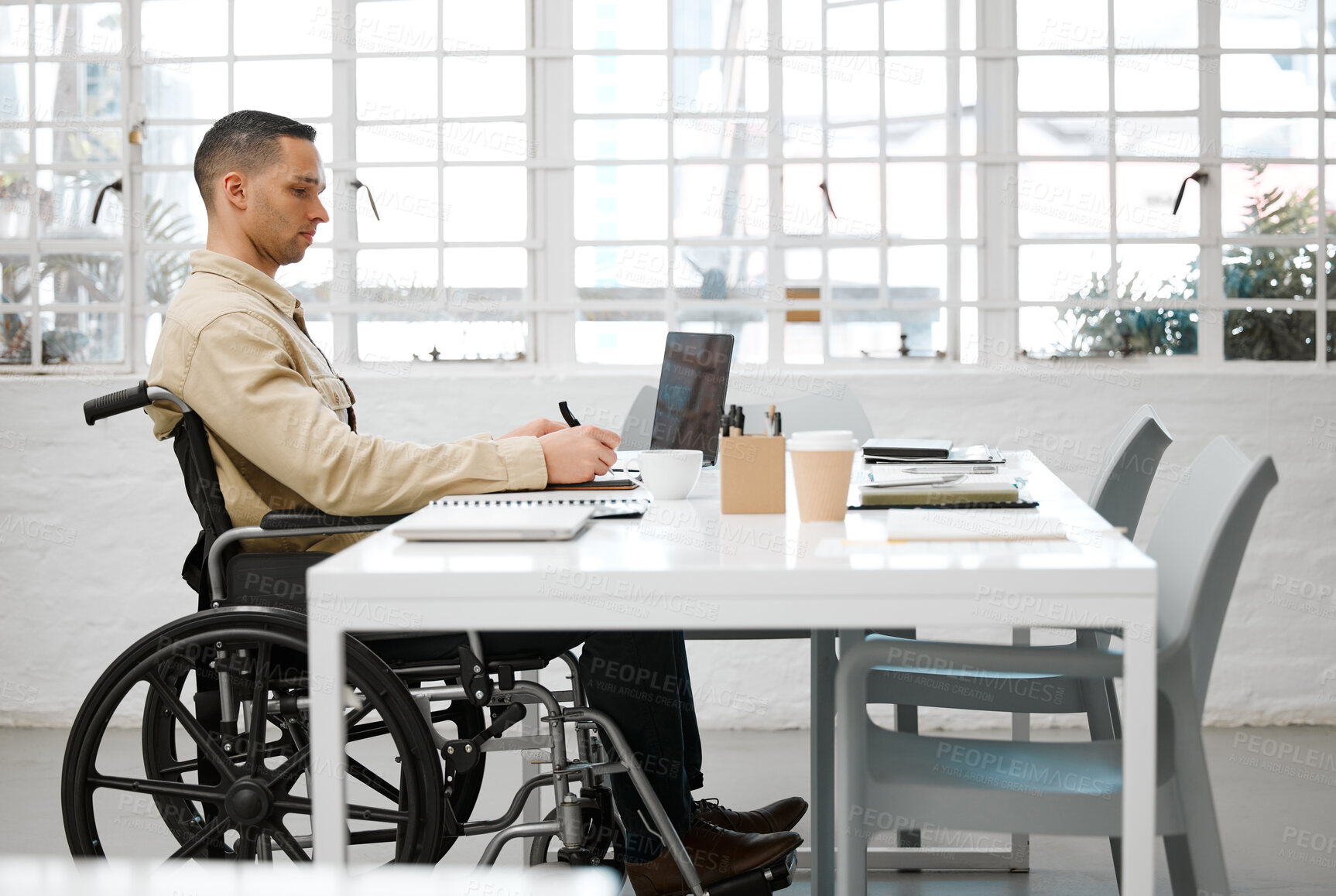 Buy stock photo Wheelchair, disabled and handicap business man working, planning and writing ideas in an inclusive, accessible and independent office workplace. Physically impaired, focused and serious entrepreneur