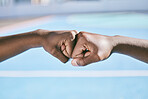 Closeup of hands, fist bump and the teamwork of two athletic, sporty, and active male athletes. Team of  black people, friends or teammates working together showing respect, collaboration and support