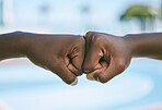 Success, support and hands giving fist bump for motivation, celebration and standing in unity outside in nature. Closeup of people showing passion, growth and connection against a blurred background