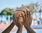 Basketball players, team sport and competition match enjoying a fun recreation game on an outdoor community court. Closeup of hands holding, grabbing and reaching to touch ball while playing 