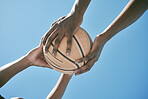 Basketball, sports and competition with two players holding a ball against a blue sky with copy space from below. Closeup hands of two black male athletes playing or training for a game outside