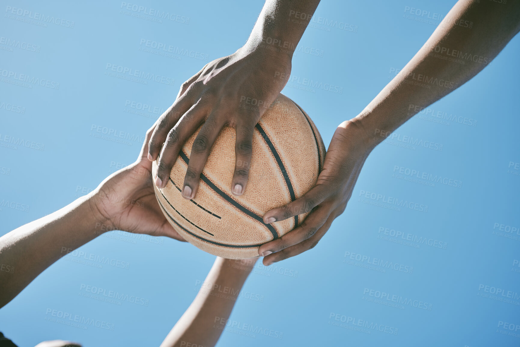 Buy stock photo Basketball, sports and competition with players holding a ball against a blue sky with copy space from below. Closeup hands of black male athletes and friends playing or training for a game outside