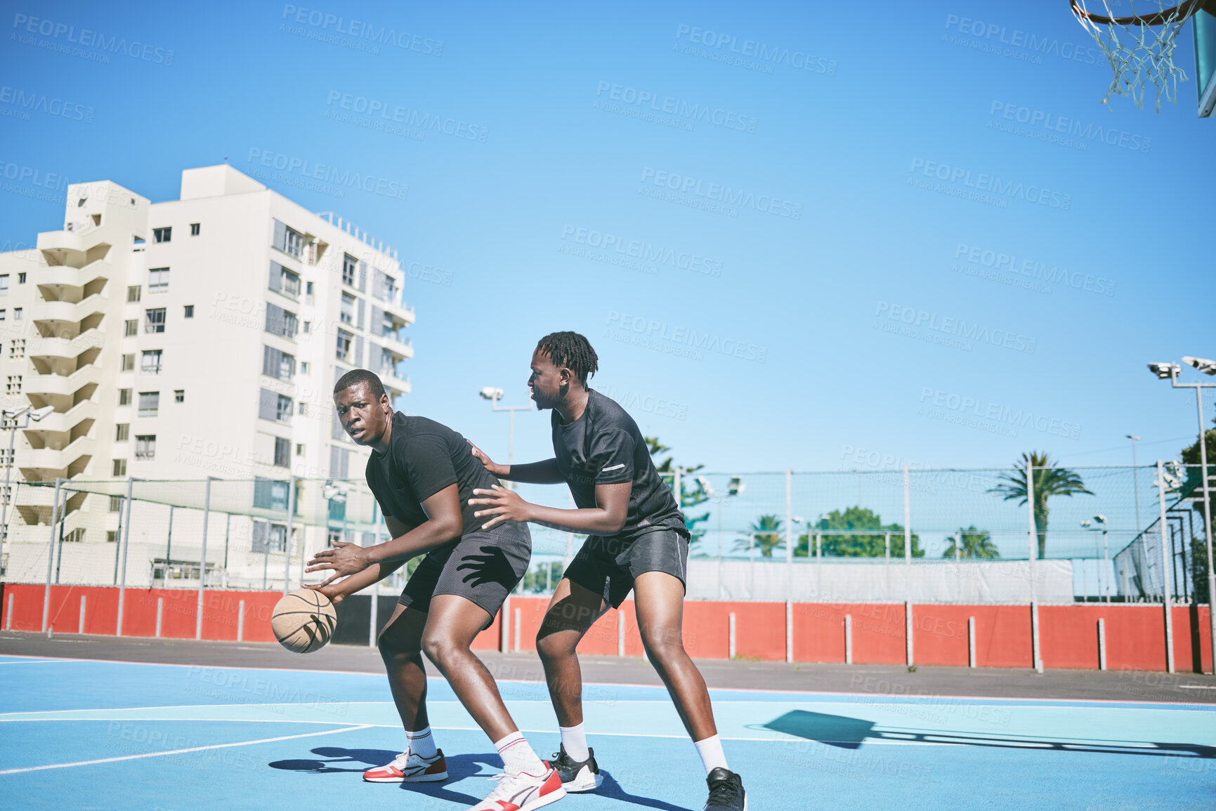 Buy stock photo Basketball, sports and game between sporty male players having fun while playing on a court outdoors. Young black friends training and being active together while competing in a competitive sport