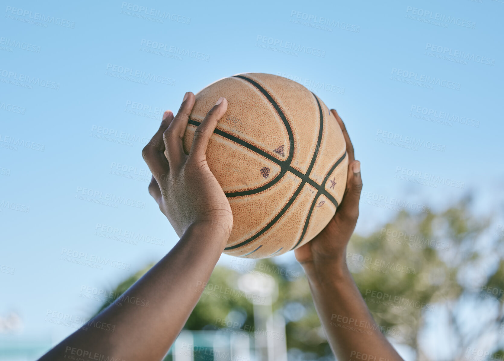 Buy stock photo Basketball, sport and playing with a ball in the hands of a player, athlete or professional sportsperson. Closeup of a game or match outside on a court for health, recreation and fun in the sun