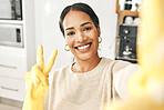 Happy, smiling and clean domestic taking a selfie with a peace sign hand gesture at home. Carefree woman enjoying good hygiene while cleaning, doing chores and housework alone expressing happiness.