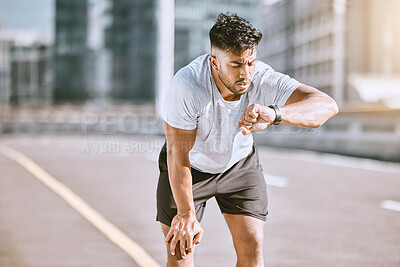 Buy stock photo Fitness, tired and runner checking watch for running speed, pace and time in routine workout, exercise and city training. Fit, active and healthy man monitoring wellness, endurance and cardio health