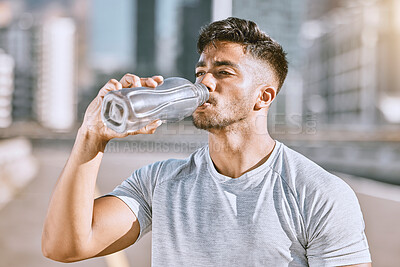 Buy stock photo Drinking water, fit and healthy man living an active health, wellness and body or weight watching lifestyle. Athletic running, fitness and sports lover staying cool after workout or training routine