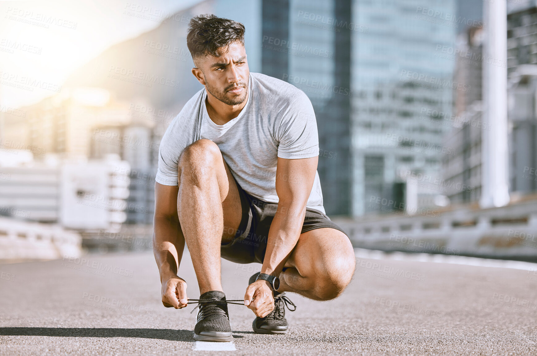 Buy stock photo Tie shoes, fit and healthy man ready for a run, exercise and workout or training routine in urban city. Active athletic male living a health, wellness and body or weight watching fitness lifestyle