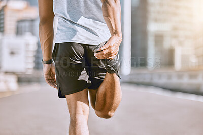 Buy stock photo Fit, health and active runner stretching his leg before running or training in the city for a morning workout routine. Closeup of wellness male athlete or sportsman preparing for his fitness exercise