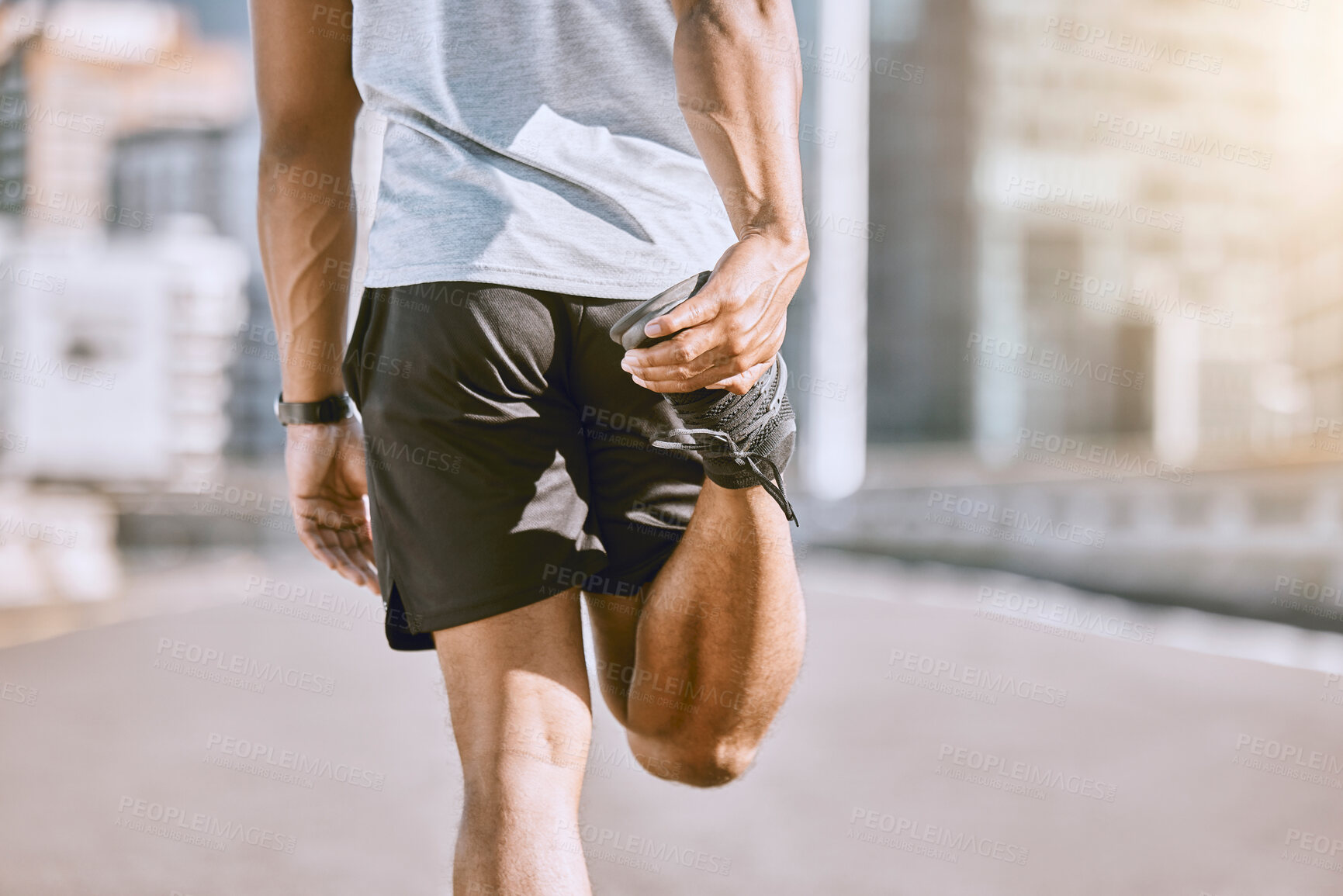 Buy stock photo Fit, health and active runner stretching his leg before running or training in the city for a morning workout routine. Closeup of wellness male athlete or sportsman preparing for his fitness exercise