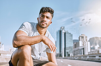 Buy stock photo Exhausted, runner and fitness athlete taking a break after a morning cardio workout at sunrise. Tired, urban male jogger resting after exercise and kneeling in the city after a training marathon.