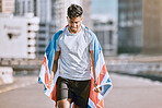 Fitness, training and workout with a sports man in an american flag running a marathon in the city. Health, exercise and wellness with an olympic athlete or runner exercising for cardio and endurance