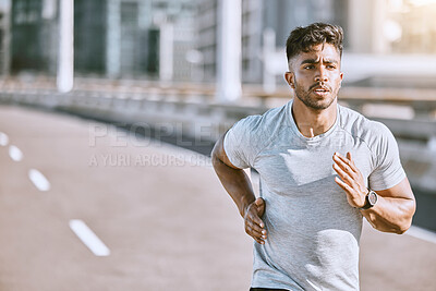 Buy stock photo Runner running for fitness training on the street in urban city, doing cardio exercise and sport on the street. Serious, fit and sporty man jogging for health, exercising and doing routine run
